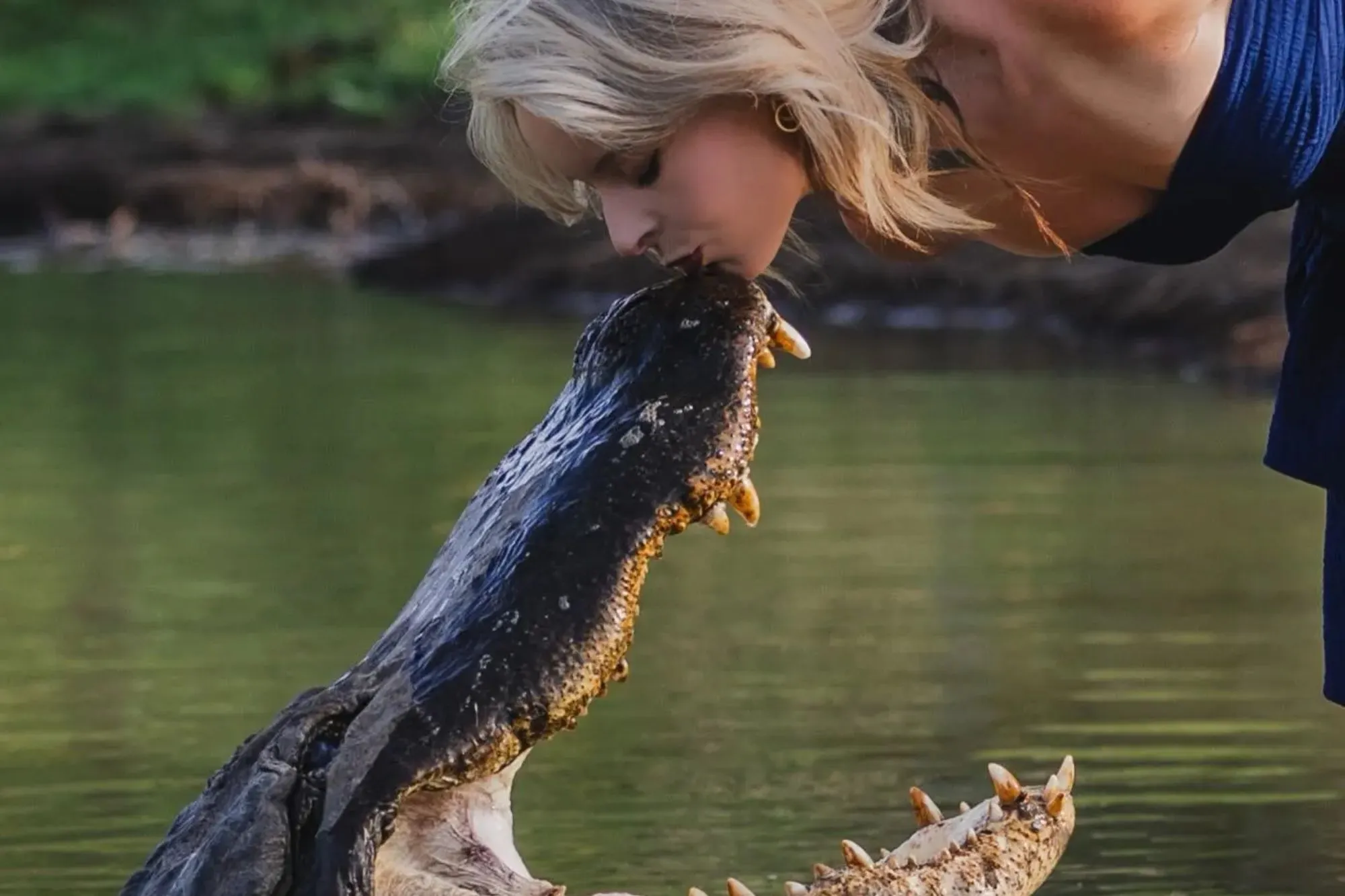 Shocking moment glam graduate KISSES alligator to celebrate degree in jaw-dropping photoshoot