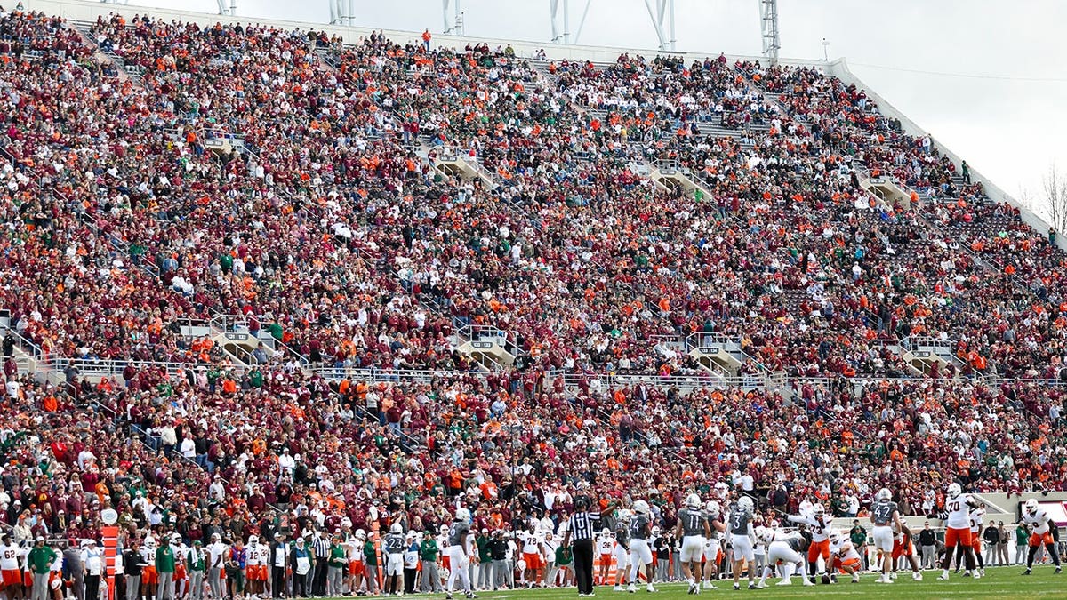 Skydiver’s parachute gets stuck on scoreboard at Virginia Tech spring game in harrowing scene