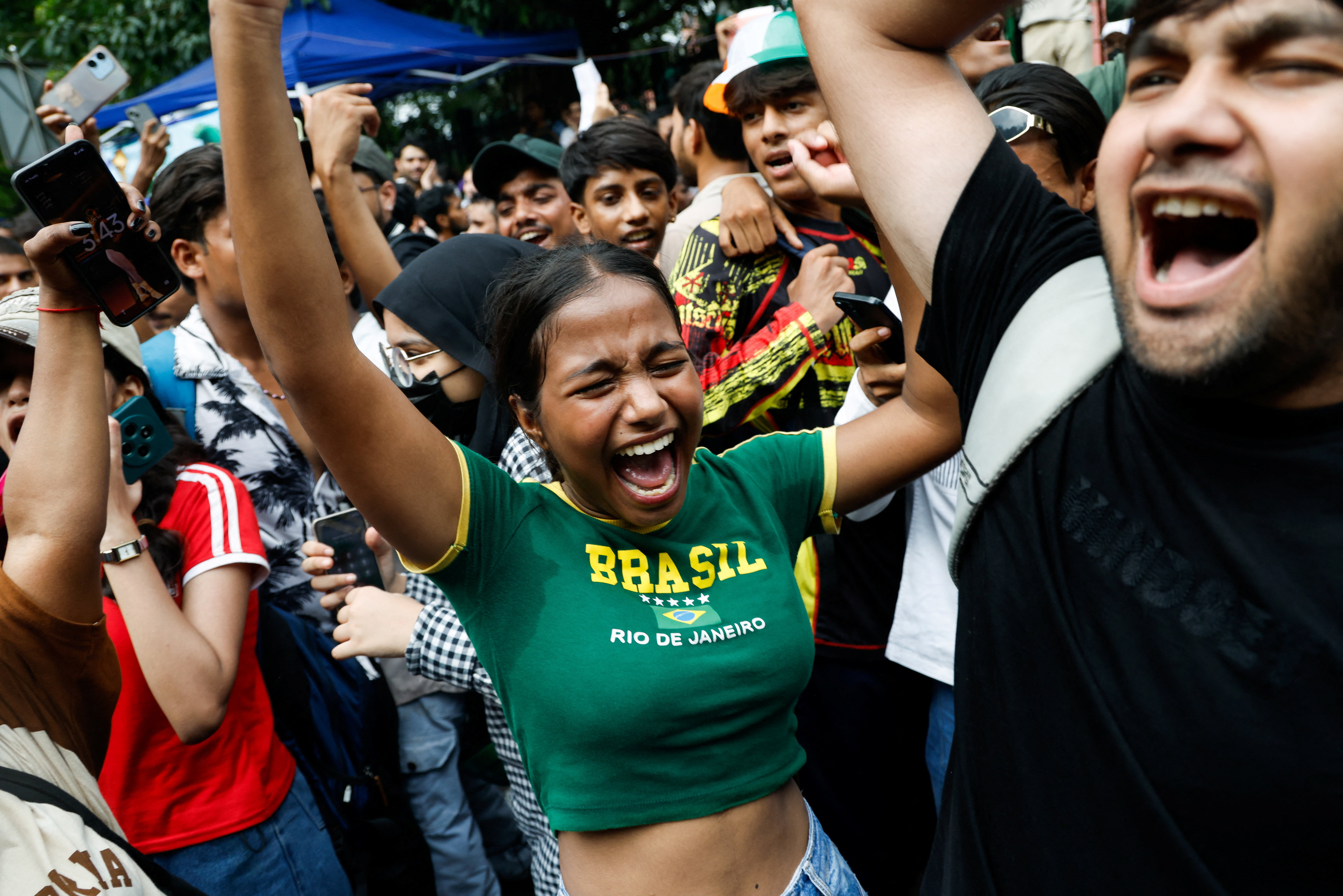 Youth protesters celebrate after India's education minister resigns following exam leak scandal