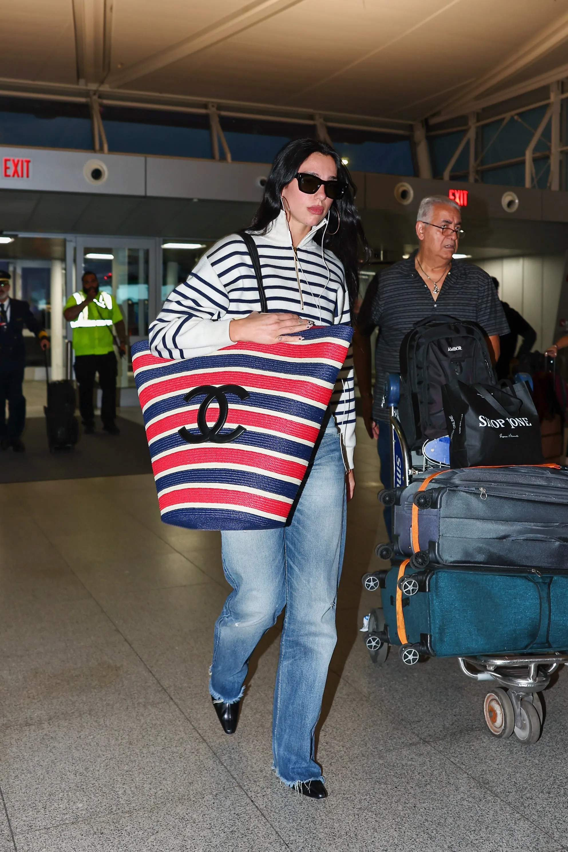 Dua Lipa Supersizes the Vacation Tote Bag—Airline Restrictions Be Damned